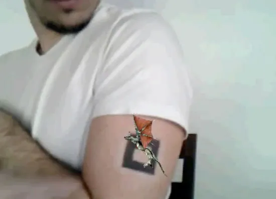 Tattoo of a cat and fish on a person's upper arm