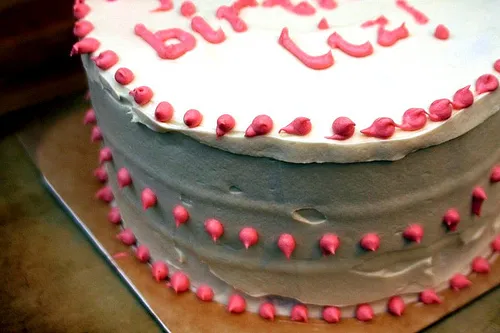 Birthday cake with pink frosting and "Happy Birthday Liz!" written on top.