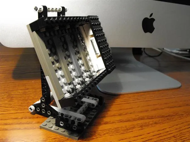 Lego display stand next to a computer.