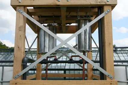 Industrial structure with metallic components and wooden framework.