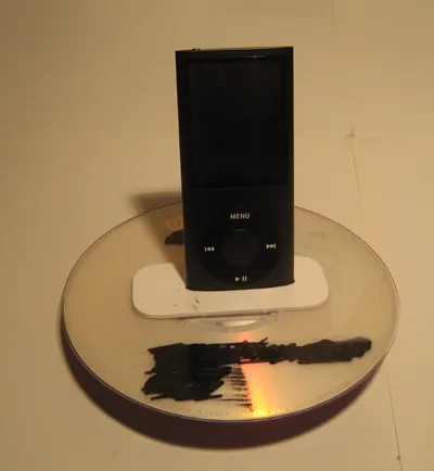 Digital media player on a reflective surface.