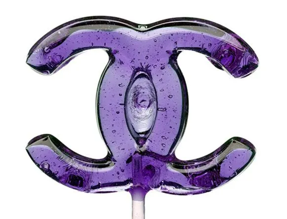 Purple lollipop in the shape of the Chanel logo.