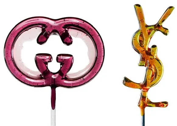 Candy-shaped logos of Gucci and YSL on sticks.