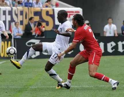 Soccer players competing for the ball during a match.