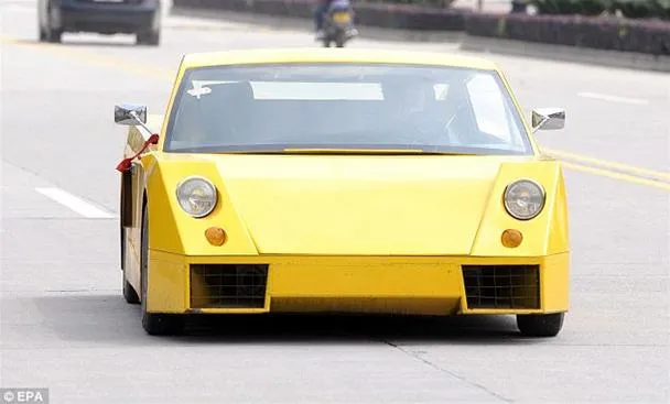 Classic yellow sports car on the road.