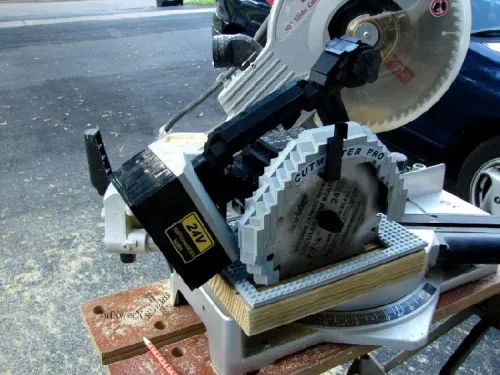 Miter saw on a workbench.