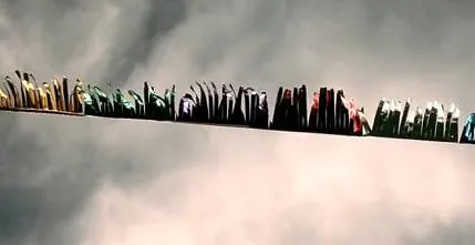 Books arranged on a narrow line against a cloudy background.