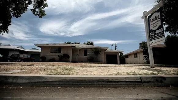 Real estate property for sale with a "For Sale" sign in front.