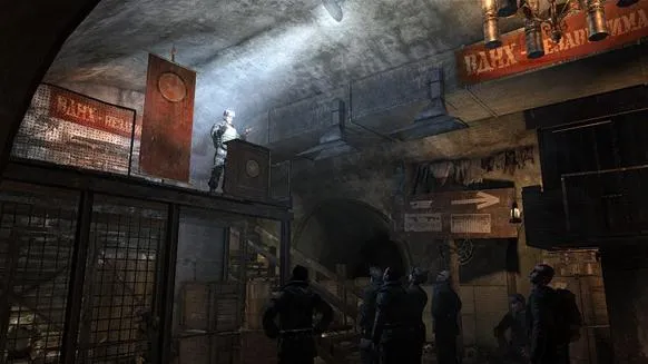 A dimly lit underground setting with a speaker on a platform, surrounded by banners and attentive audience members.