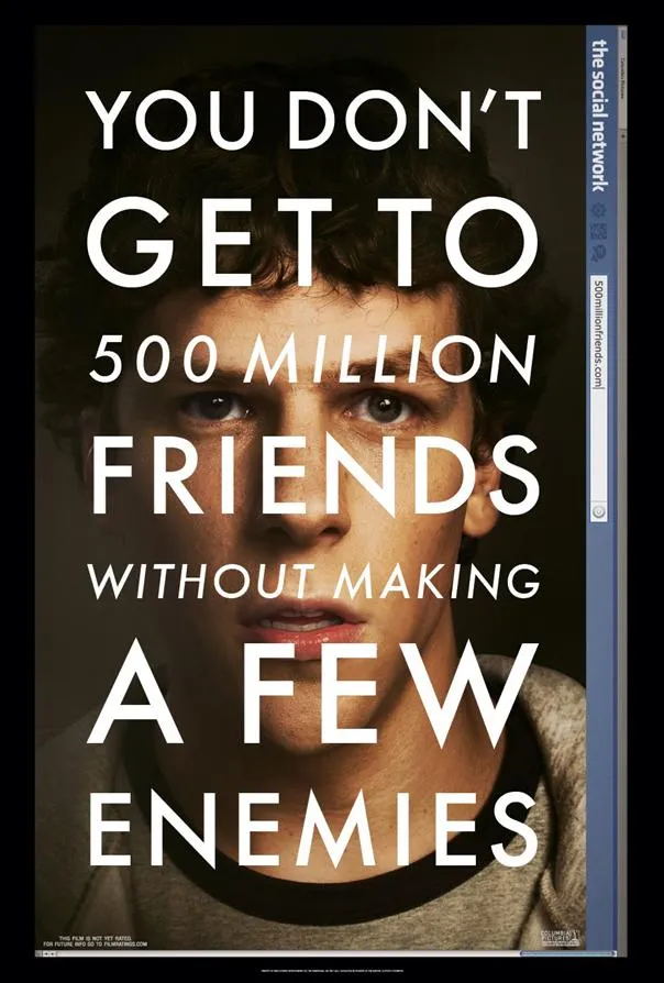 Movie poster for "The Social Network" featuring a close-up of a young man's face with the tagline about friendships and enemies.