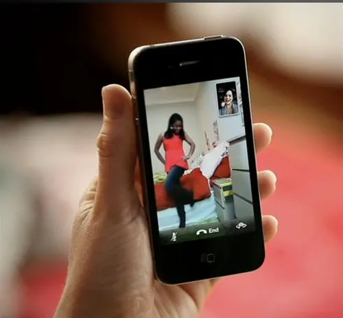Person on a video call while holding a smartphone.