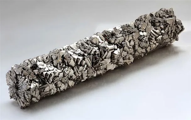 Metallic substance in a complex, textured form.
