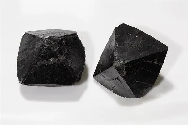 Black gemstones with rough surfaces.