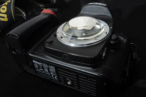 Digital camera on a black surface.