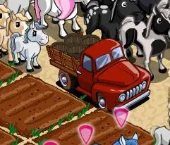 Red truck parked among farm animals.
