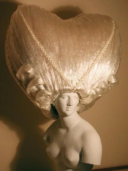 Artistic mannequin with a large, heart-shaped headpiece.