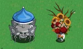 Garden gazebo with a blue roof and a vase of colorful flowers.
