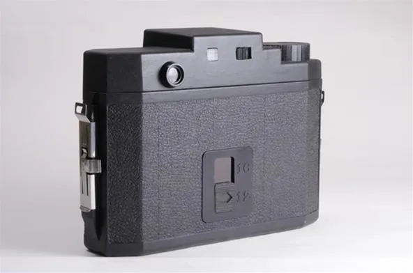 Vintage black camera against a white background.