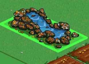 Decorative pond surrounded by rocks and grass.