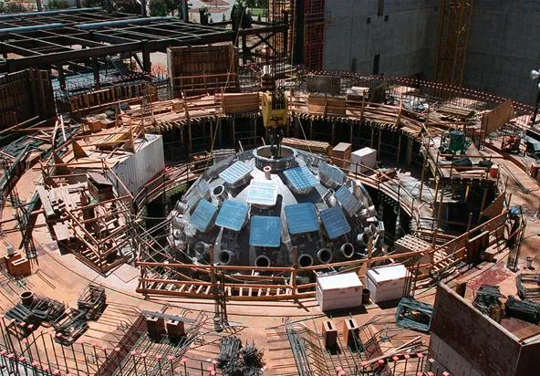 Construction of a dome structure with scaffolding and equipment.