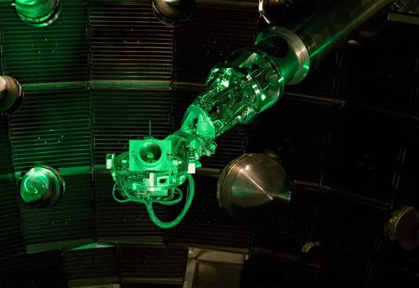 Robotic arm surrounded by a high-tech environment with green lighting.
