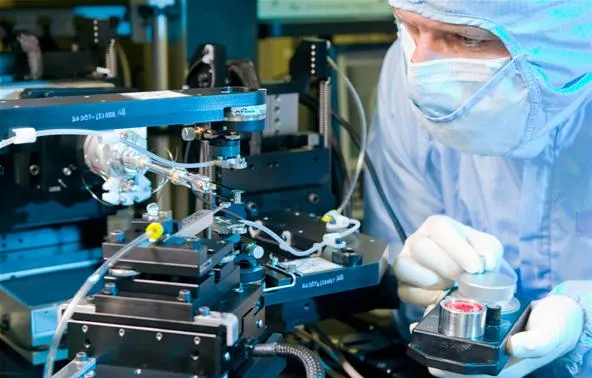 Scientist working in a laboratory with precision equipment.