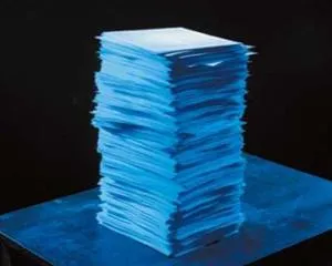 Stack of blue papers on a dark background.