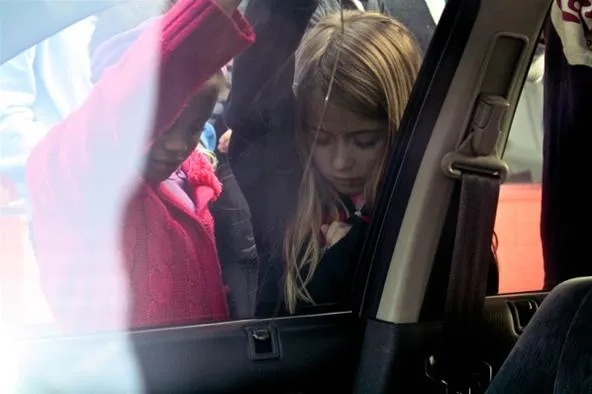 Children exploring inside a car.