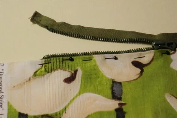 Zippered pouch with a colorful design featuring white birds on a green background.