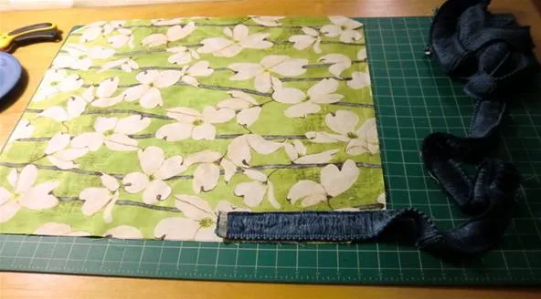 Fabric with a floral pattern on a cutting mat
