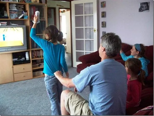 A family enjoying a video game in a living room with a television.