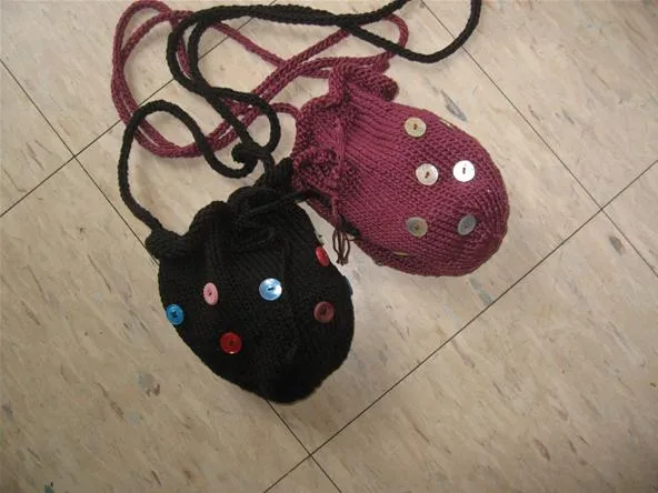 Handmade fabric pouches with decorative buttons.