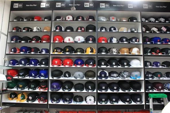 Display of various sports helmets organized on shelves.