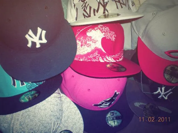 A collection of colorful baseball caps stacked together.