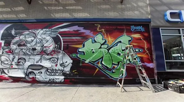Colorful graffiti mural featuring abstract designs and a ladder against a wall.