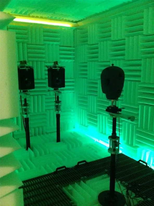 Microphone setup in a soundproof recording studio with green lighting.