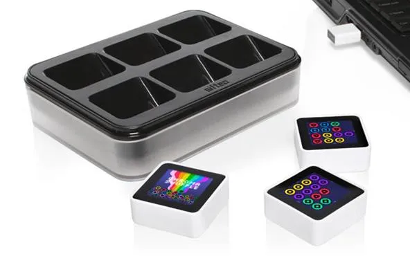 Colorful silicone molds for ice cubes and desserts, arranged with a tray and three decorative display cubes.