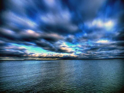 Scenic view of a cloudy sky over calm waters.