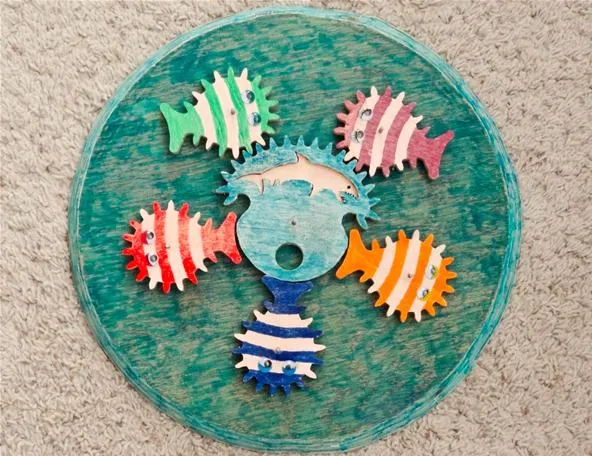 Colorful decorative fish design on a circular background.