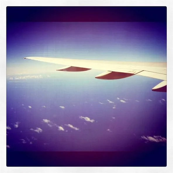 Airplane wing above the clouds.