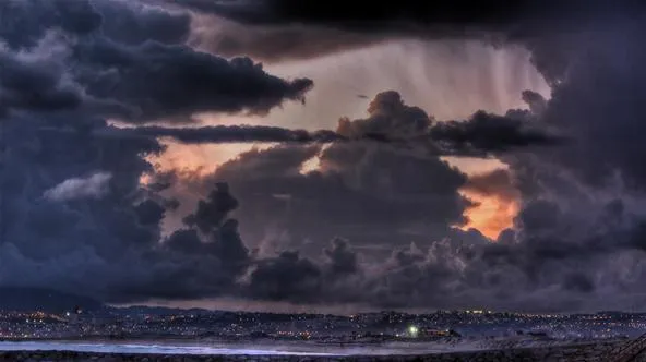 Dramatic clouds over a twilight landscape.
