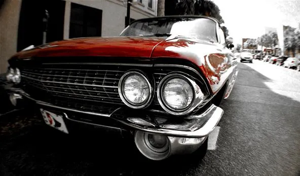 Classic red vintage car parked on the street.