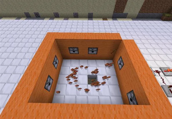 A square orange enclosure with scattered items on the white floor, featuring windows on the walls.