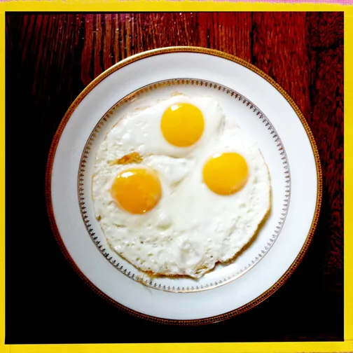 Fried eggs on a plate.