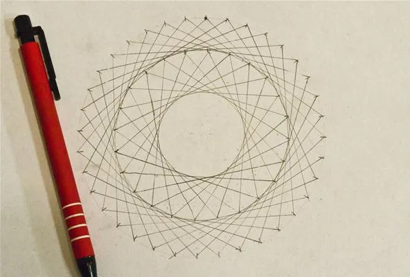 Geometric design with circular patterns and a red pen.