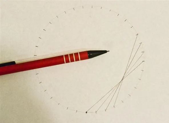 Red pencil resting on a paper circle with radiating lines.