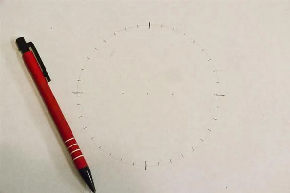 Drawing tools and a blank circular template on paper.