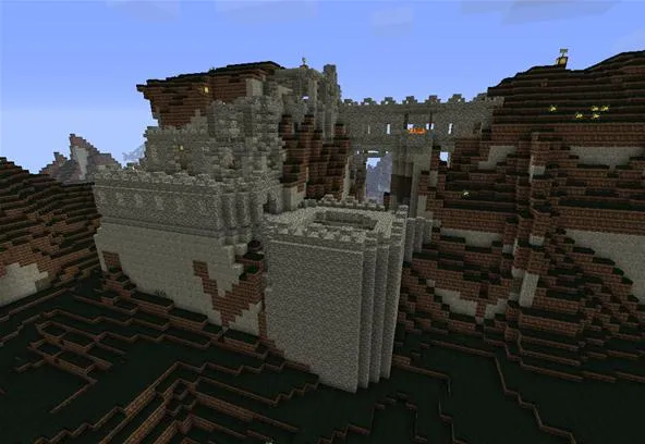 Minecraft castle built into a mountainous landscape.