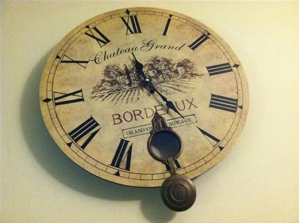 Antique wall clock with Roman numerals and vintage Bordeaux design.
