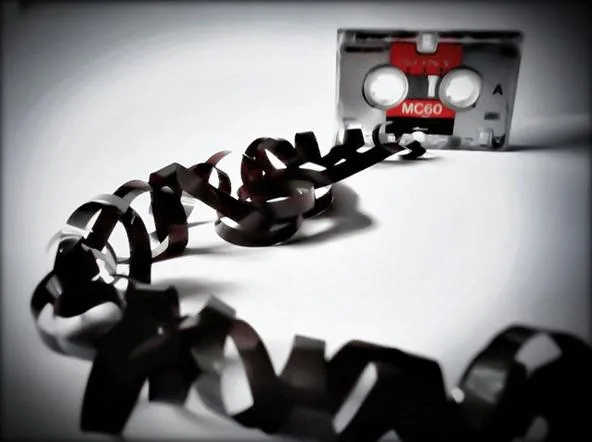Vintage cassette tape with audio tape unraveling.